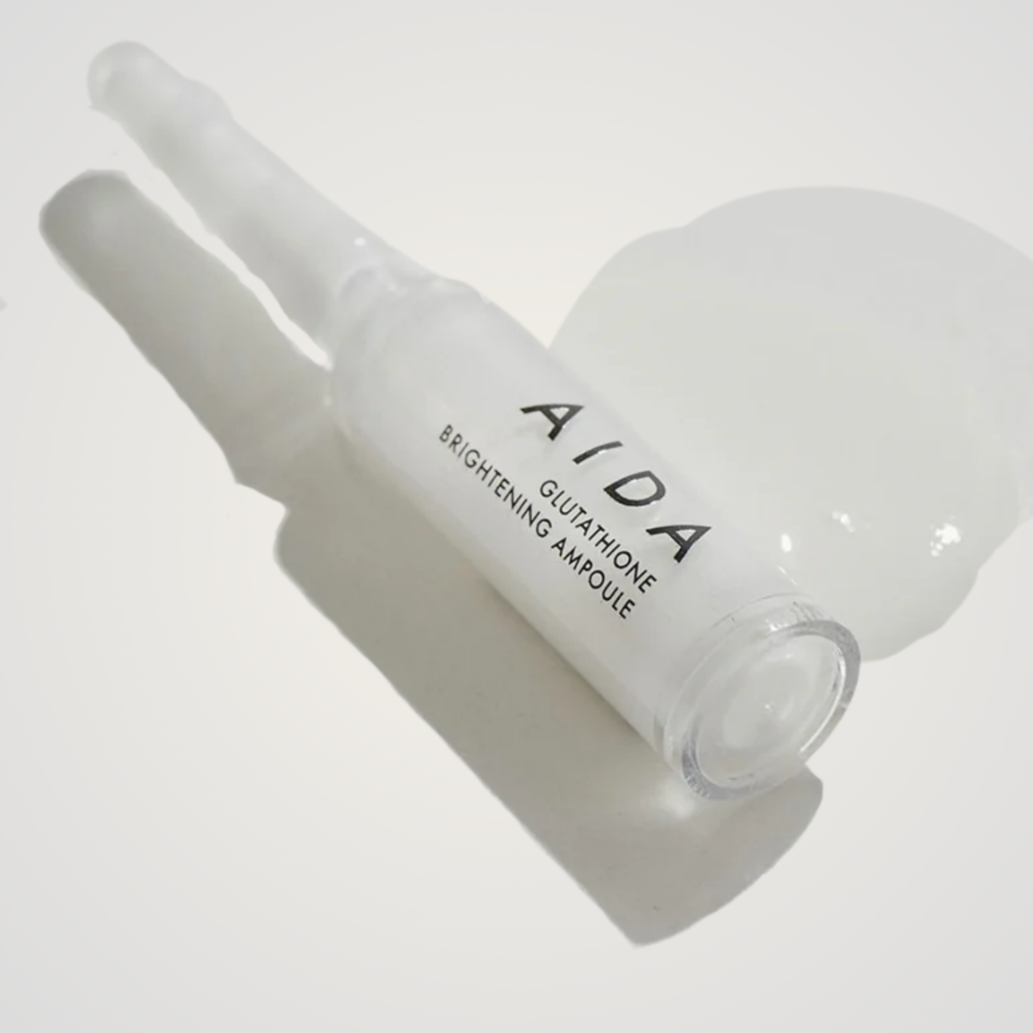 AIDA Glutathione Brightening Ampoule with silky white serum texture on neutral background