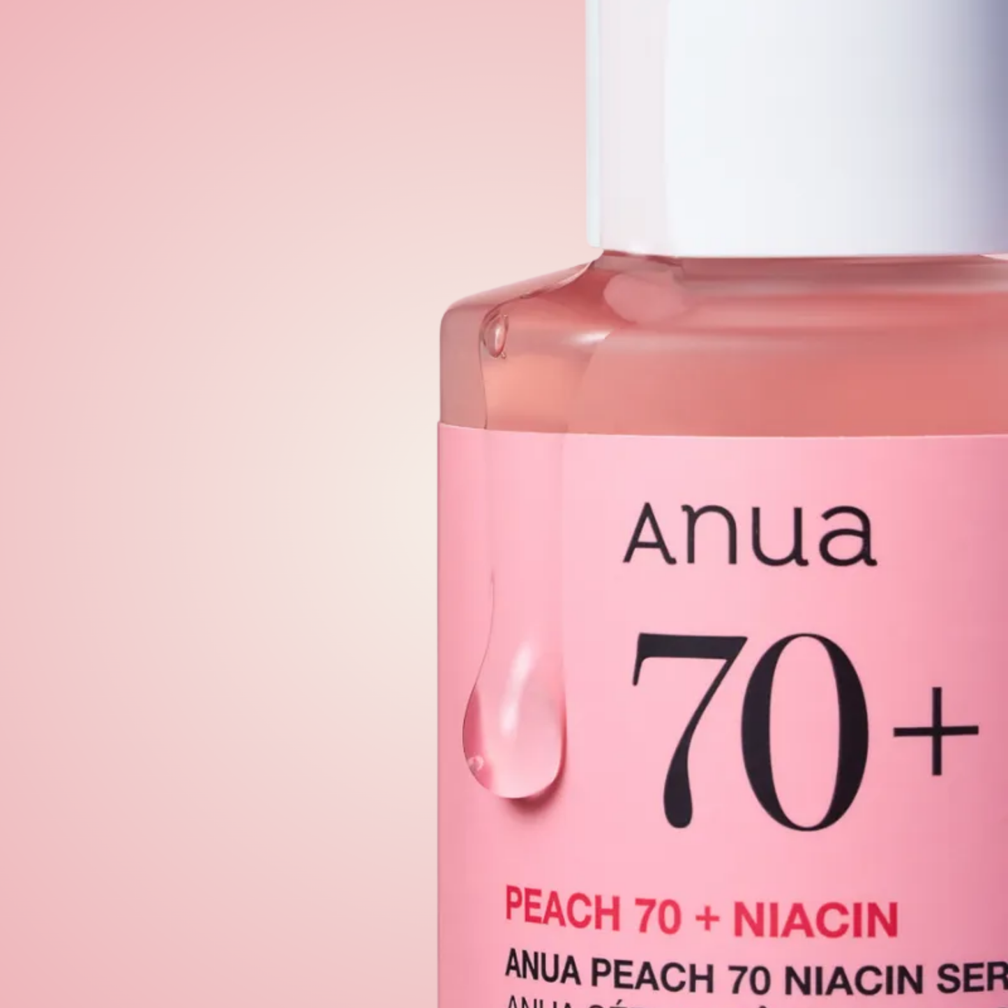 Close-up of Anua Peach 70 Niacinamide Serum bottle highlighting pink glow formula