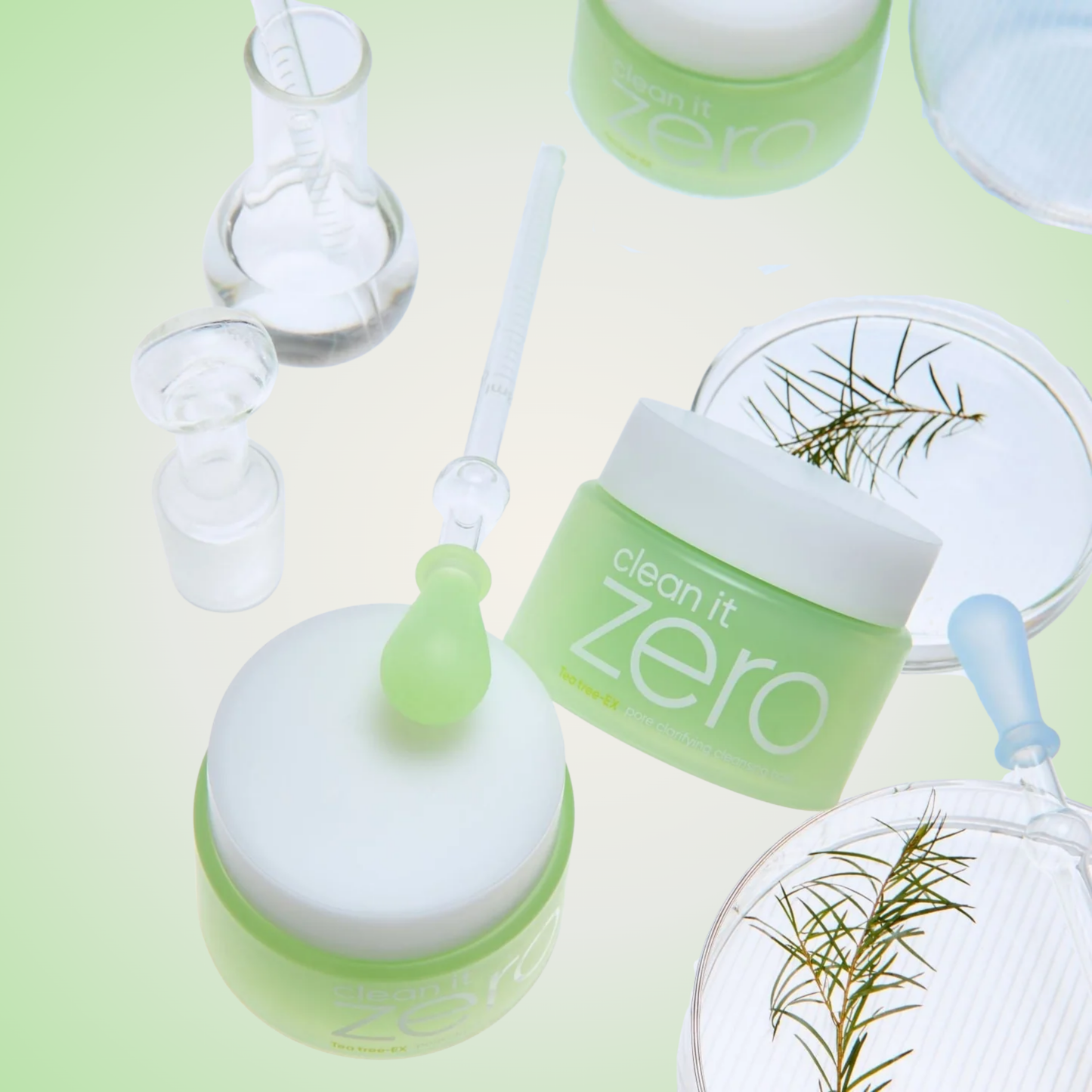 Flatlay of Banila Co Clean It Zero Pore Clarifying Cleansing Balm with tea tree leaves and lab glassware – gentle deep cleanser