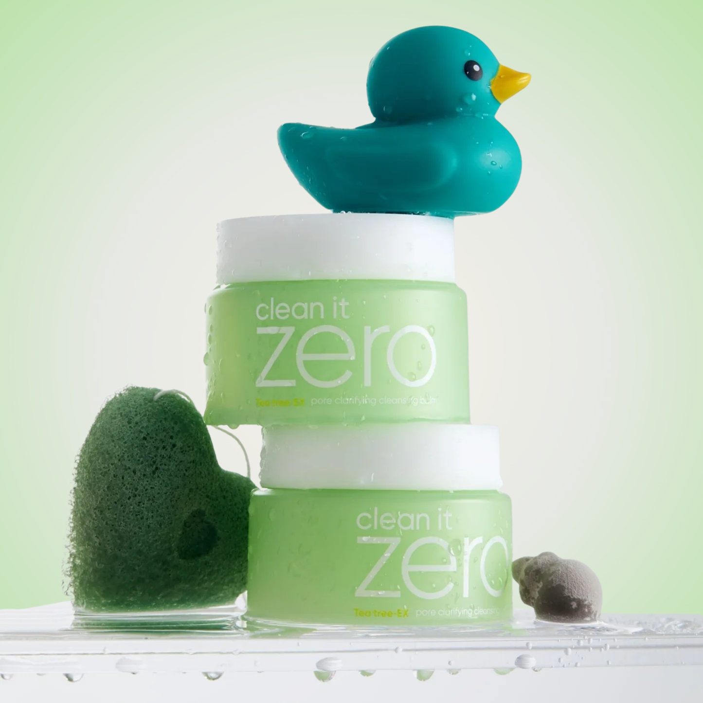 Stacked jars of Banila Co Clean It Zero Pore Clarifying Cleansing Balm with sponge and duck decor – pore-purifying cleanser