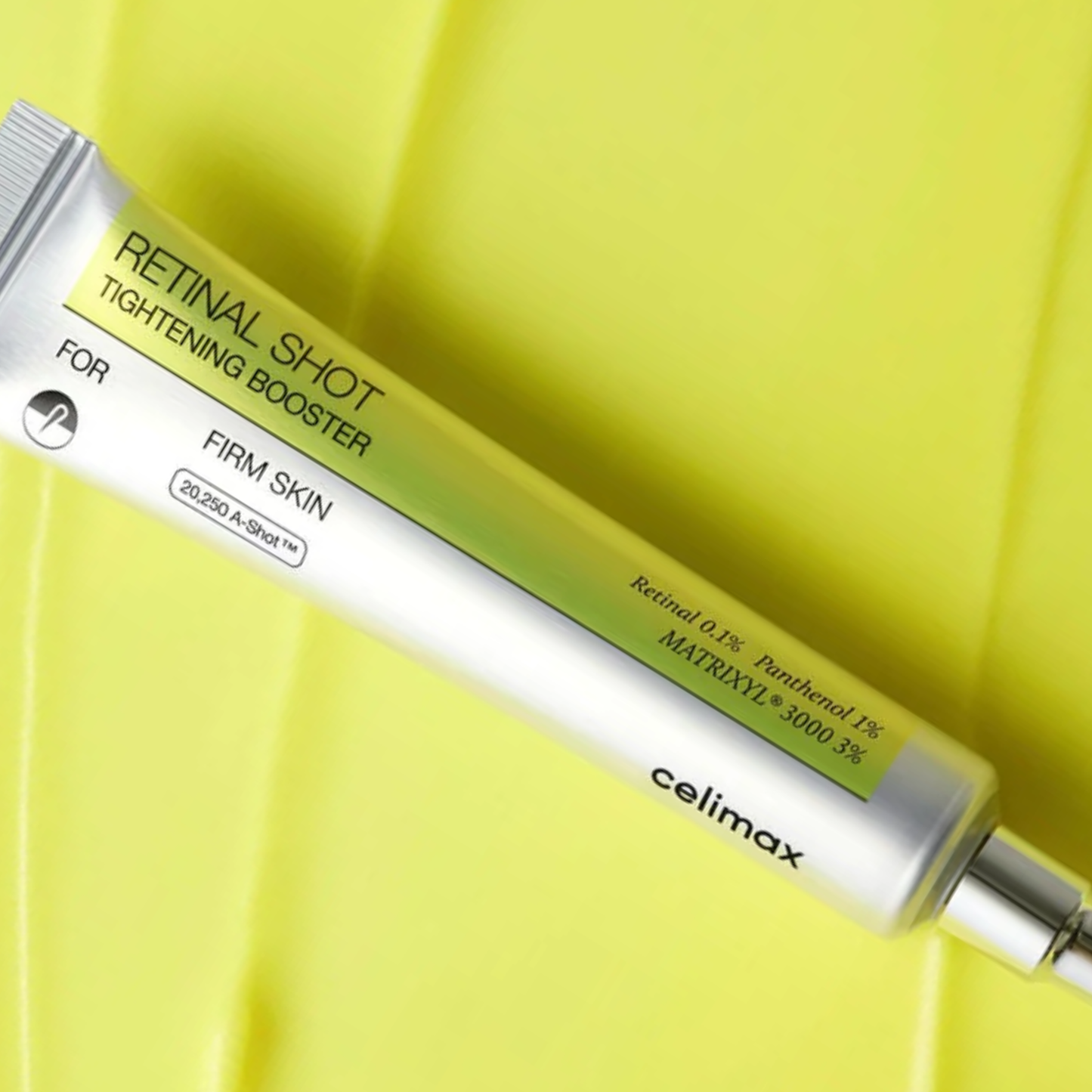 Celimax Vita-A Retinal Shot Tightening Booster tube on yellow background – anti-aging retinal cream for firmer, youthful skin.