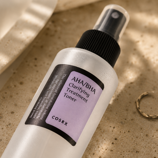 Macro close-up of the COSRX AHA/BHA Clarifying Treatment Toner bottle resting on warm beige travertine, highlighting the frosted bottle finish, fine mist spray, and label details with soft morning sunlight and a luxury Korean skincare editorial aesthetic.