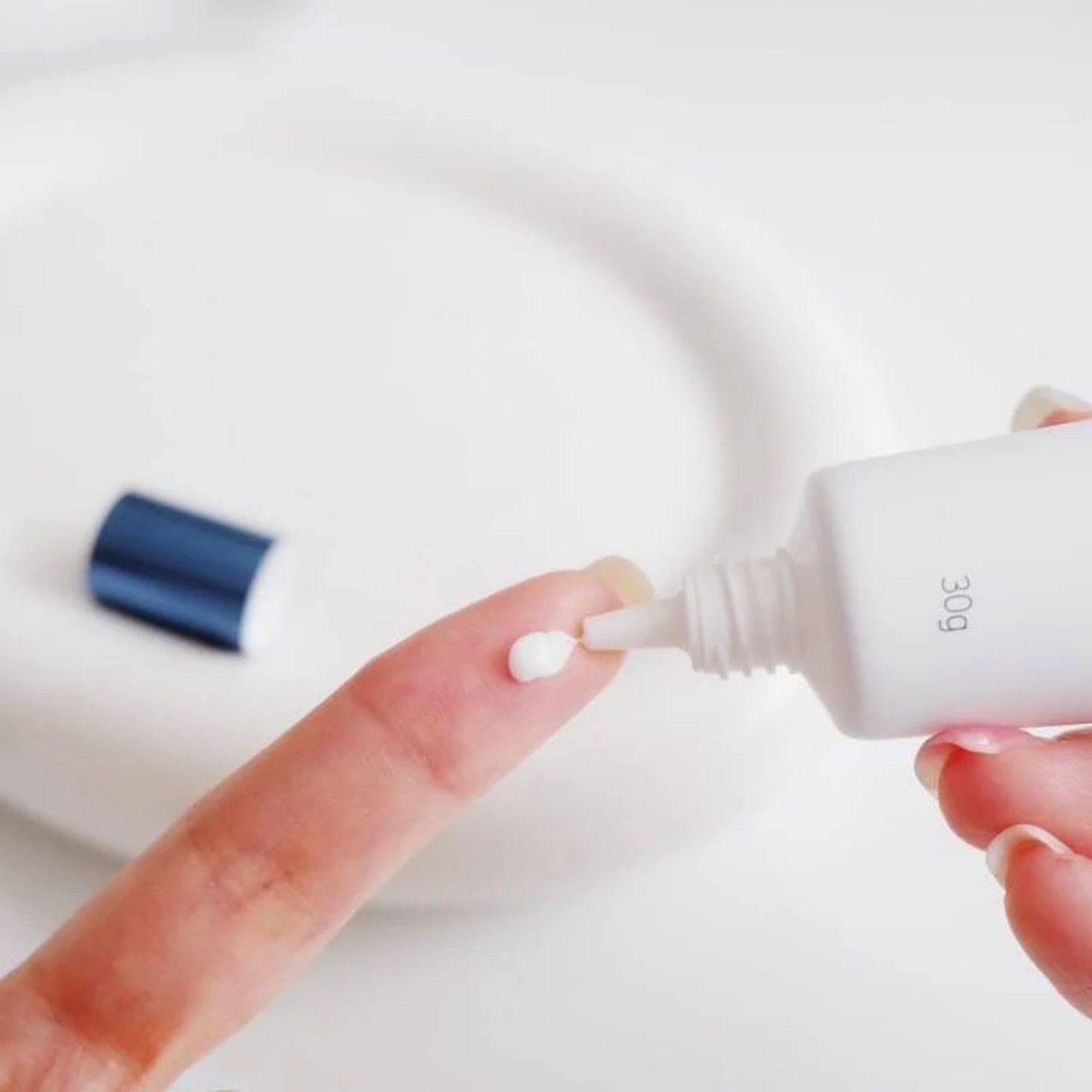 Applying Dong-A Pharm Melatoning Cream on fingertip – lightweight brightening and moisturizing texture
