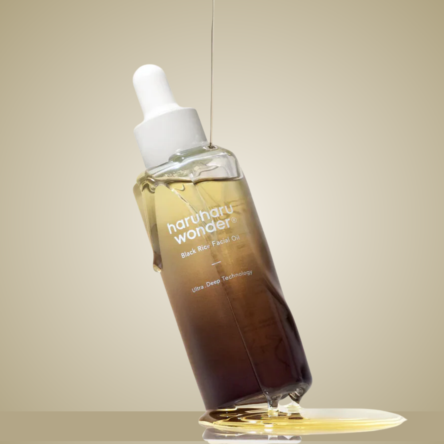 haruharu wonder Black Rice Facial Oil bottle tilted with golden oil reflection
