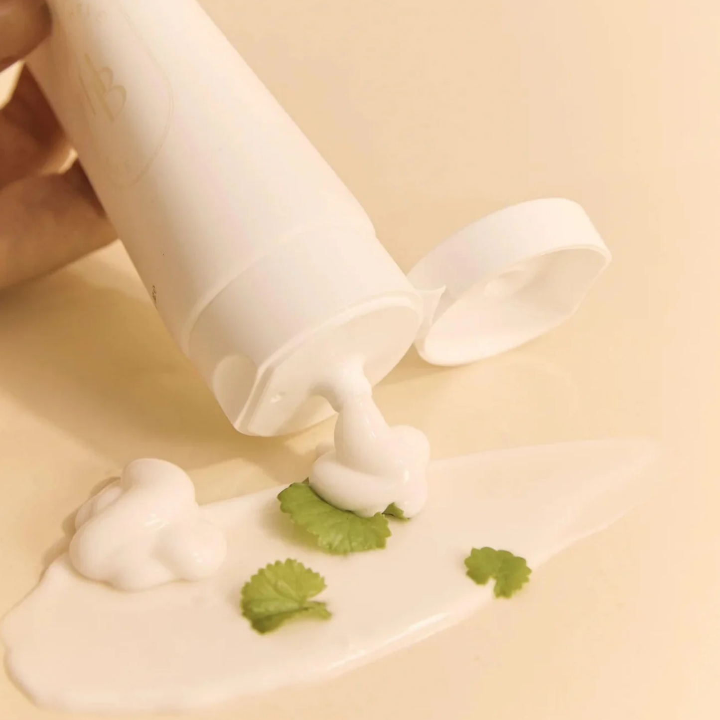 HEVEBLUE Salmon Caring Centella Cream being dispensed – lightweight cream texture with centella for soothing hydration.