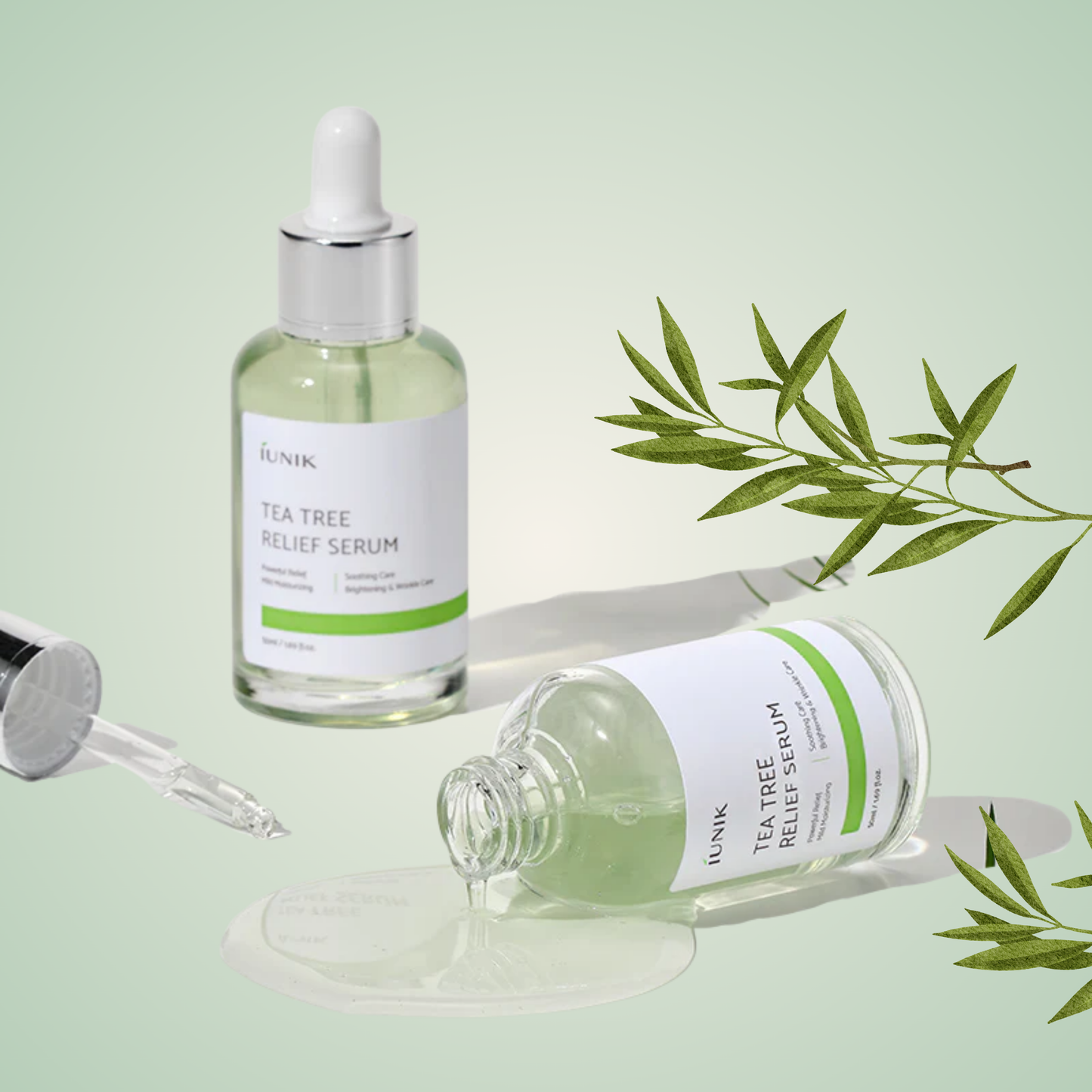 iUNIK Tea Tree Relief Serum bottle laid flat with tea tree branch