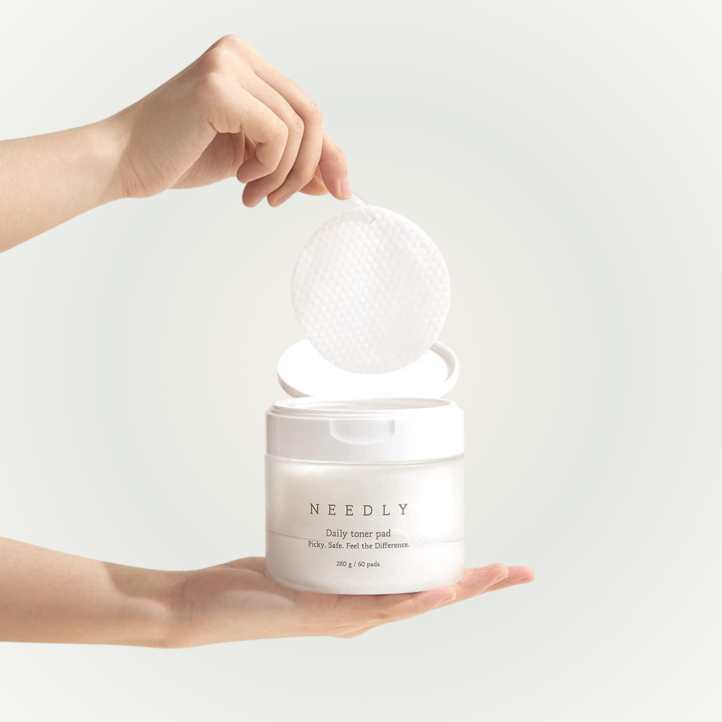 Applying Needly Daily Toner Pad on skin – mild exfoliation and hydration in one swipe