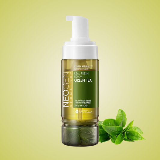 NEOGEN Real Fresh Foam Cleanser Green Tea bottle with fresh tea leaves on bright green background