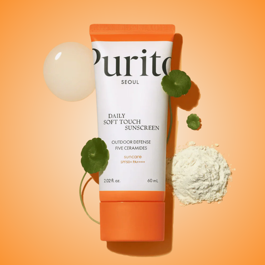 Purito Daily Soft Touch Sunscreen SPF50+ PA++++ tube with ceramide and green ingredients on orange background