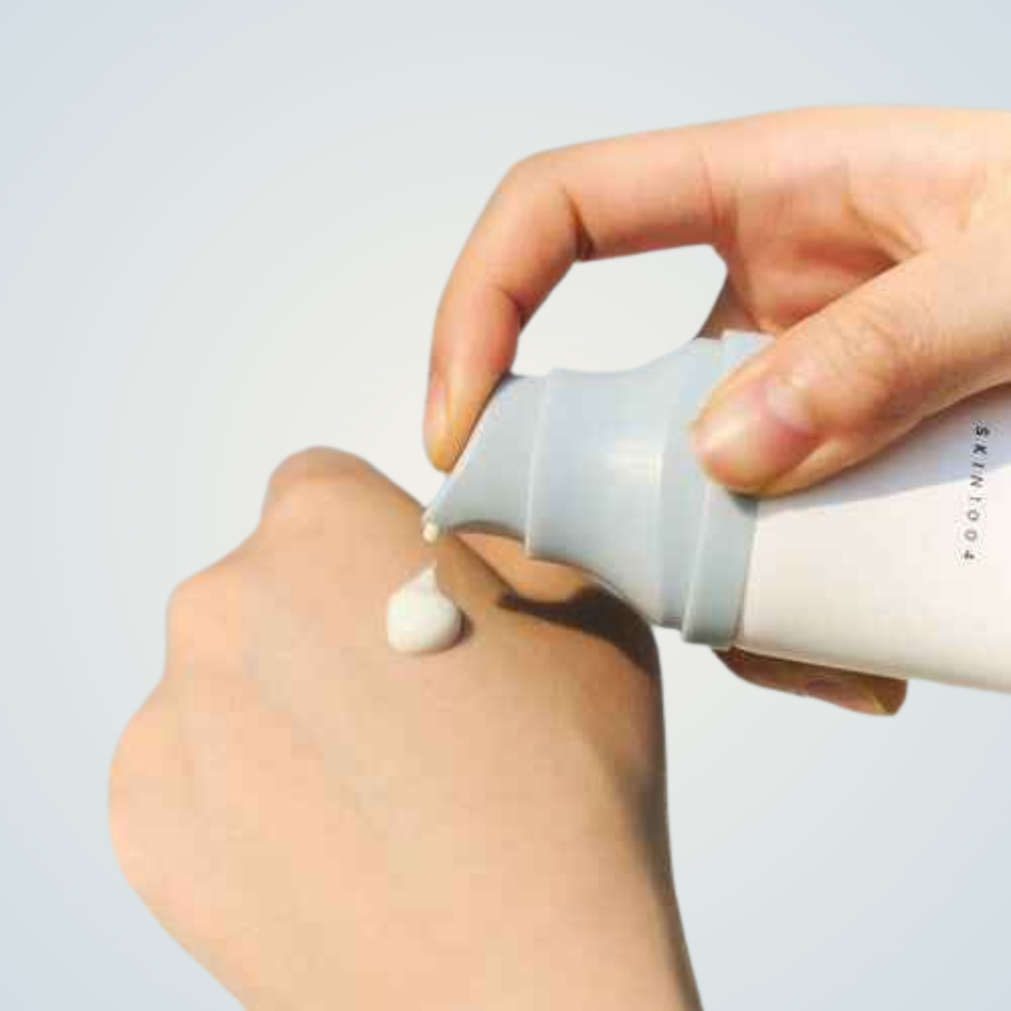 Applying SKIN1004 Madagascar Centella Hyalu-Cica Water-Fit Sun Serum – lightweight sun care for daily use.