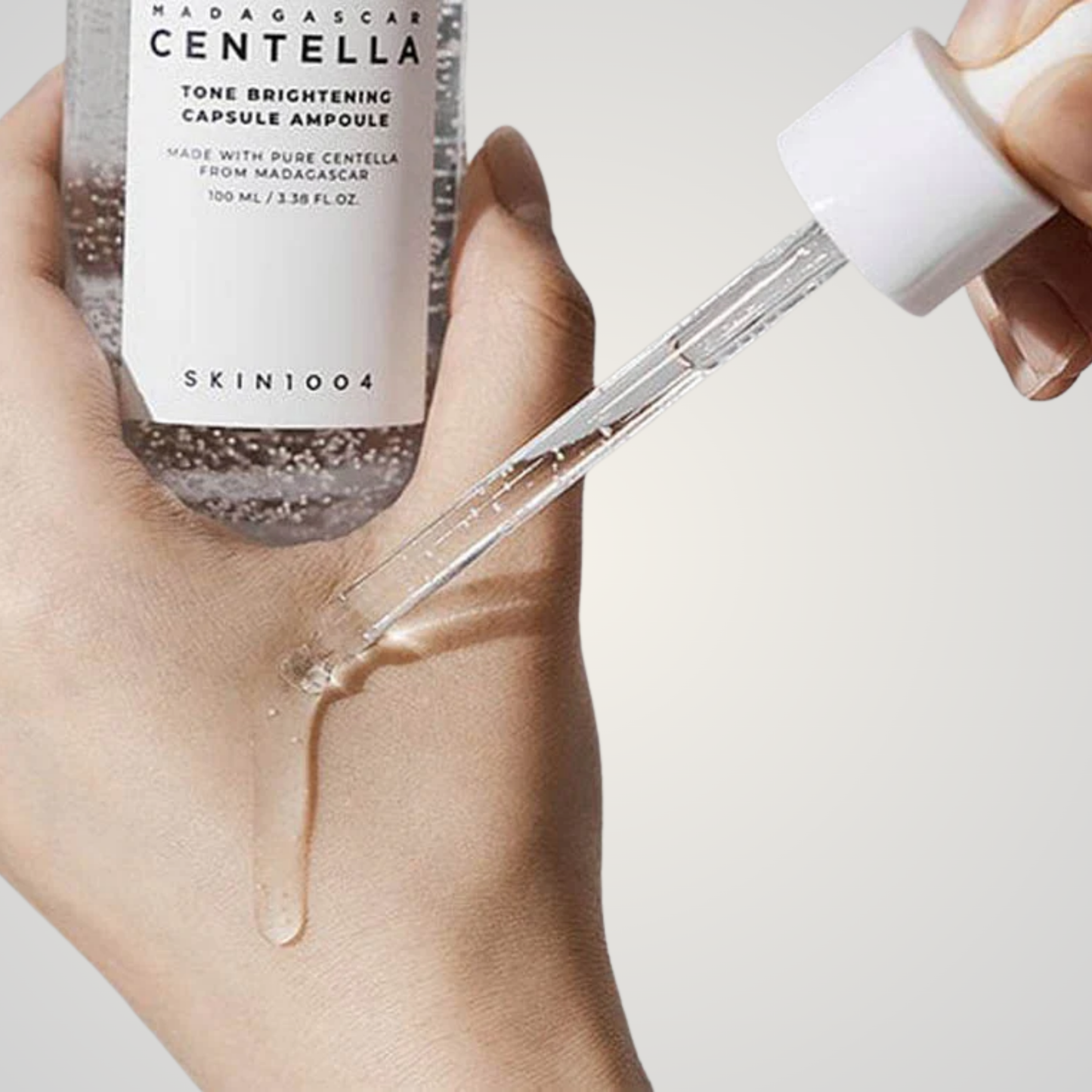 SKIN1004 Madagascar Centella Tone Brightening Capsule Ampoule – dropper applying lightweight serum to skin.