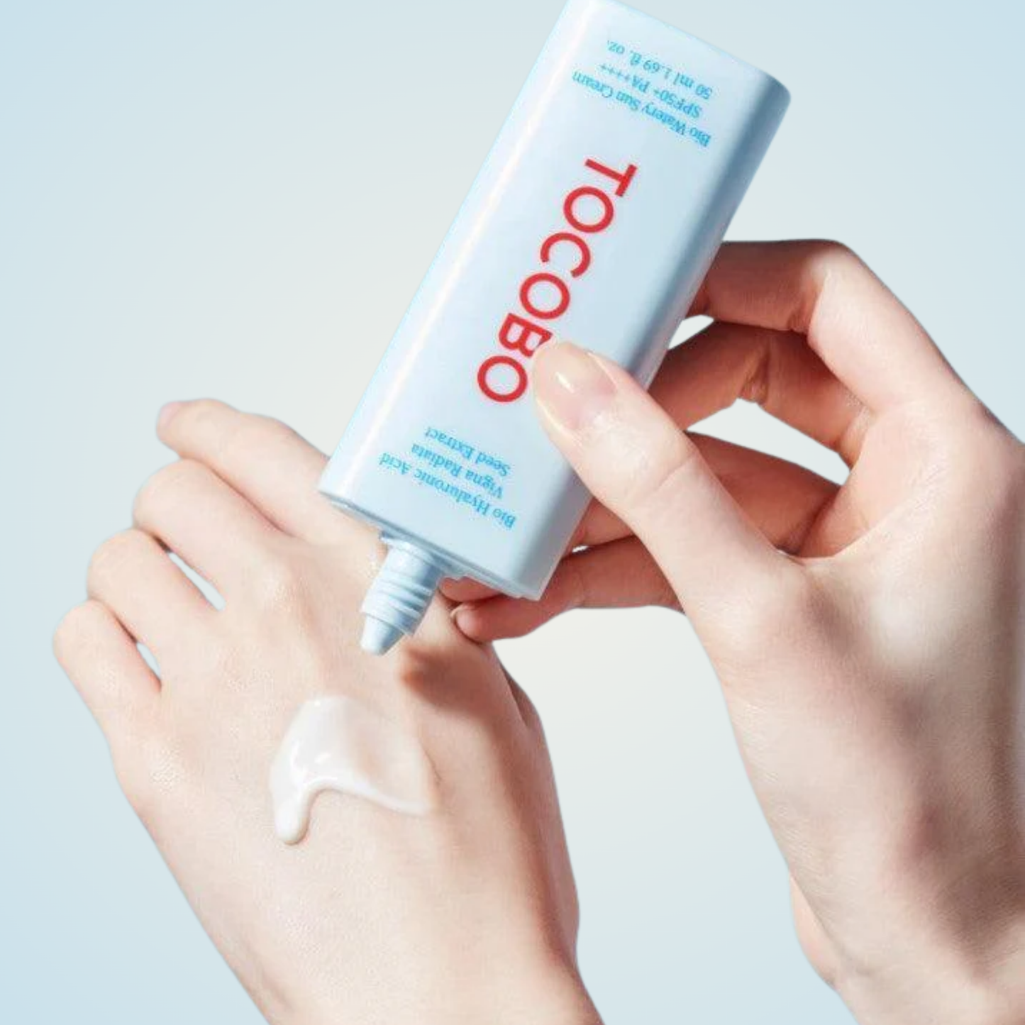 Applying TOCOBO Bio Watery Sun Cream SPF50+ PA++++ on hand – smooth, hydrating lightweight formula