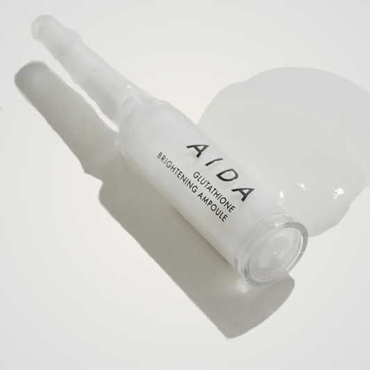 AIDA Glutathione Brightening Ampoule with silky white serum texture on neutral background