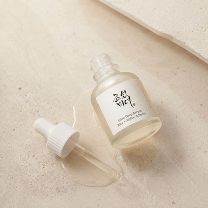 Beauty of Joseon Glow Deep Serum Rice + Alpha-Arbutin 30ml shown open with the dropper beside the bottle on warm travertine.