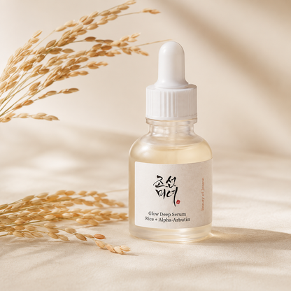 Beauty of Joseon Glow Deep Serum Rice + Alpha-Arbutin 30ml styled with rice stems in a warm editorial skincare photo.