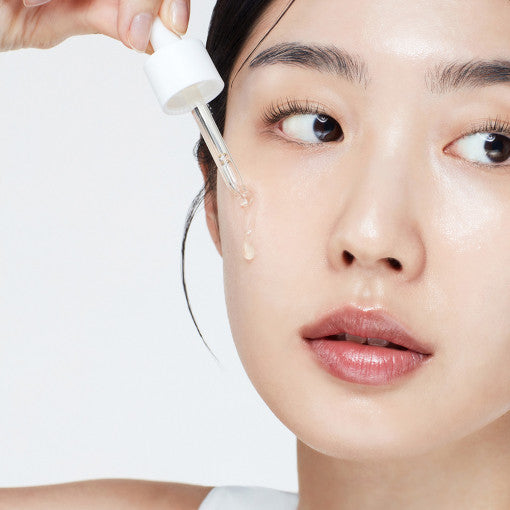 Applying Biodance Skin Glow Vital Ampoule to face for hydration and radiance