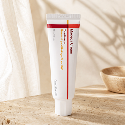 Centellian24 Madeca Cream Time Reverse 50ml displayed upright on warm travertine with soft morning sunlight in a premium Korean skincare hero photo.