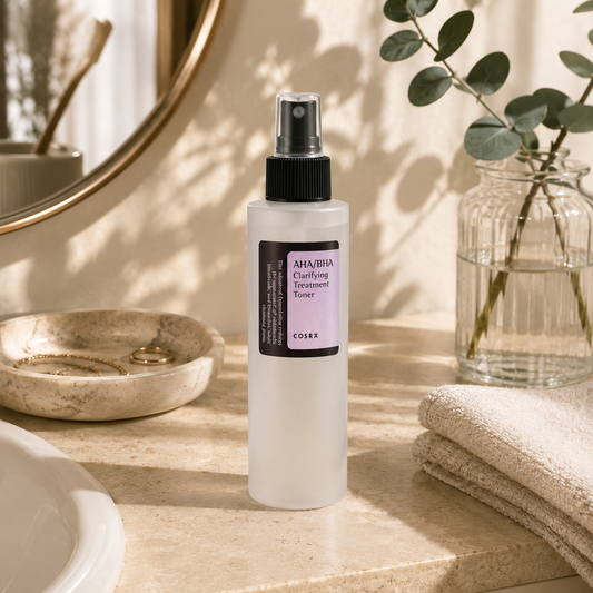 COSRX AHA/BHA Clarifying Treatment Toner displayed on a warm beige travertine bathroom vanity with folded linen towels, a glass vase with eucalyptus, soft morning sunlight, and delicate botanical shadows in a luxury Korean skincare editorial setting.