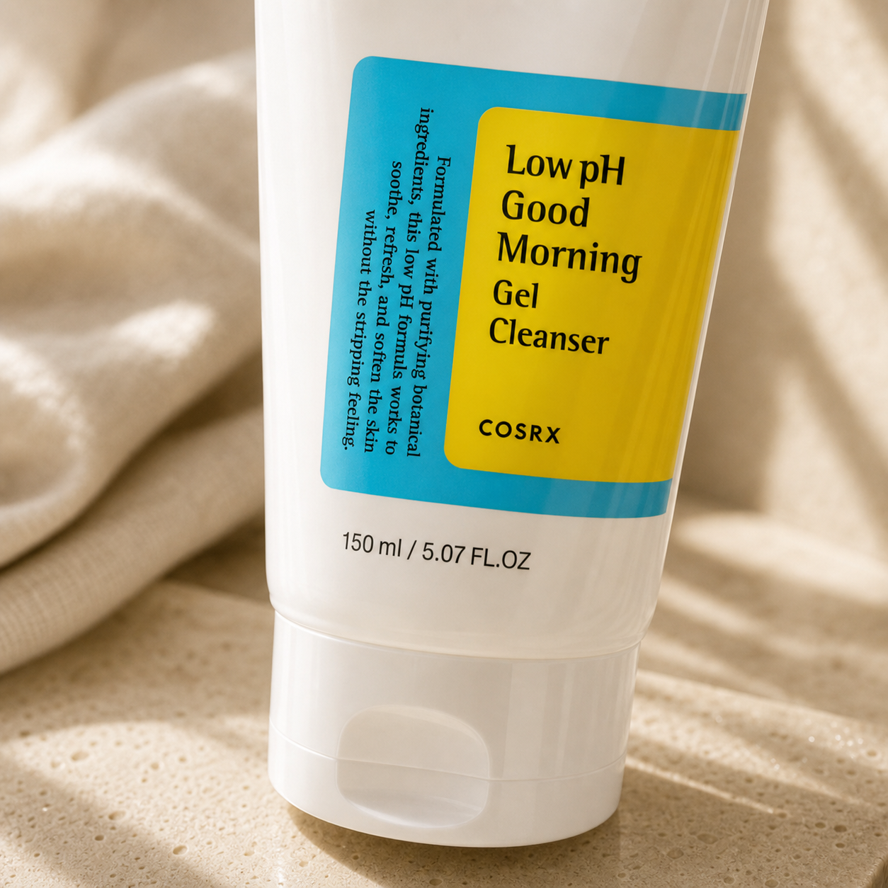 Close-up of COSRX Low pH Good Morning Gel Cleanser packaging with blue and yellow label details.