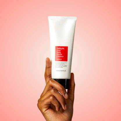 Hand holding COSRX Salicylic Acid Daily Gentle Cleanser tube – daily face wash for clear skin