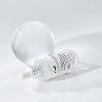 Dear, Klairs Freshly Juiced Vitamin Drop displayed on glass surface with glowing finish