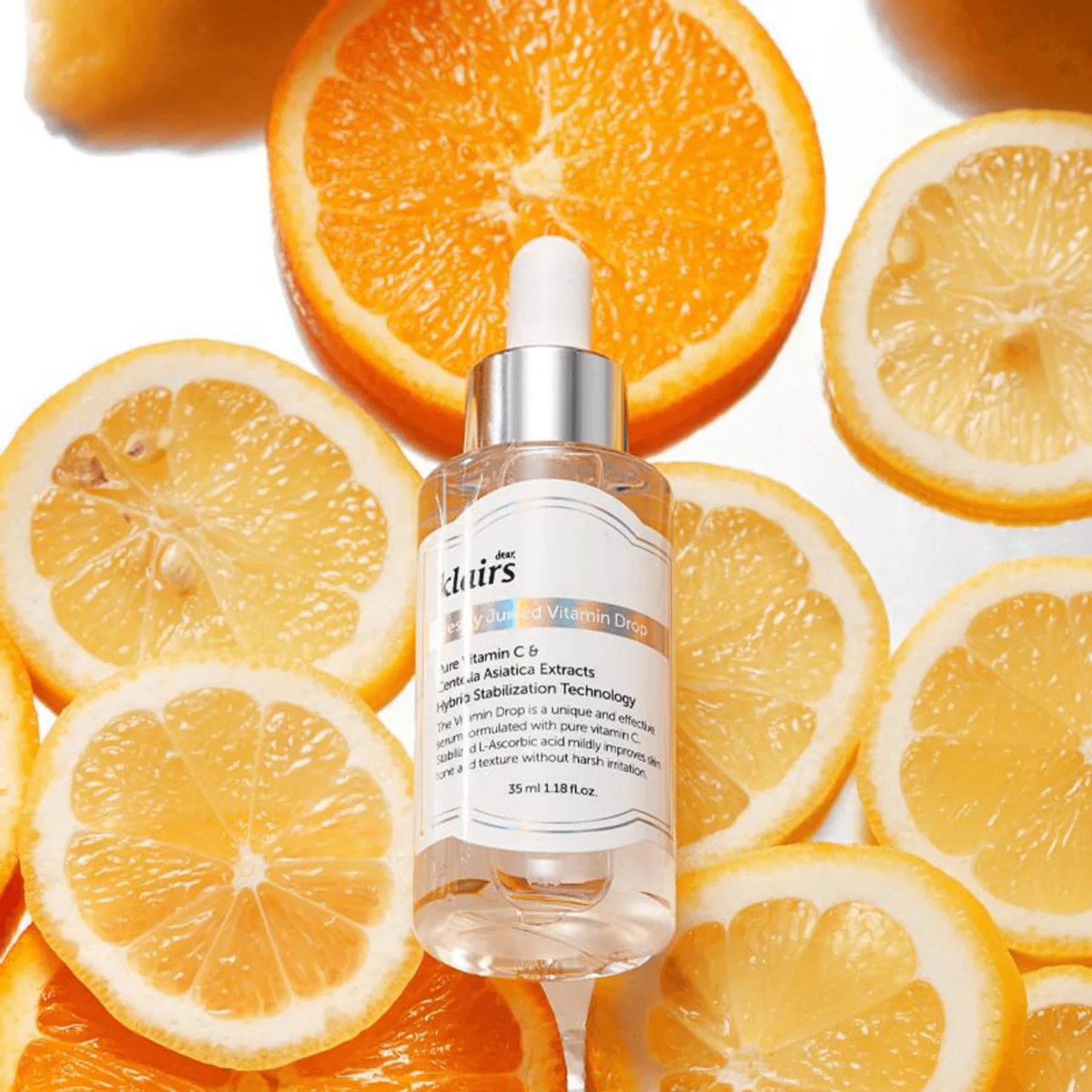 Dear, Klairs Freshly Juiced Vitamin Drop placed on sliced oranges – pure vitamin C radiance booster