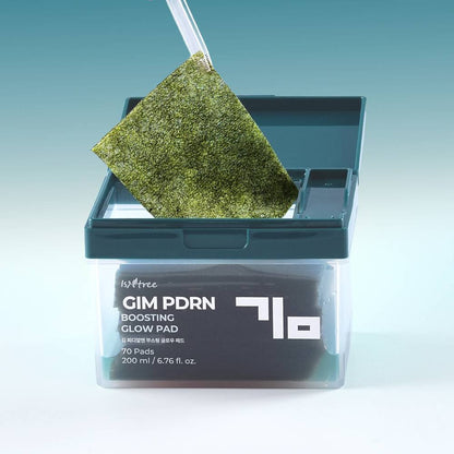 Isntree GIM PDRN Boosting Glow Pad 200ml/70ea — green toner pad lifted with tweezers.