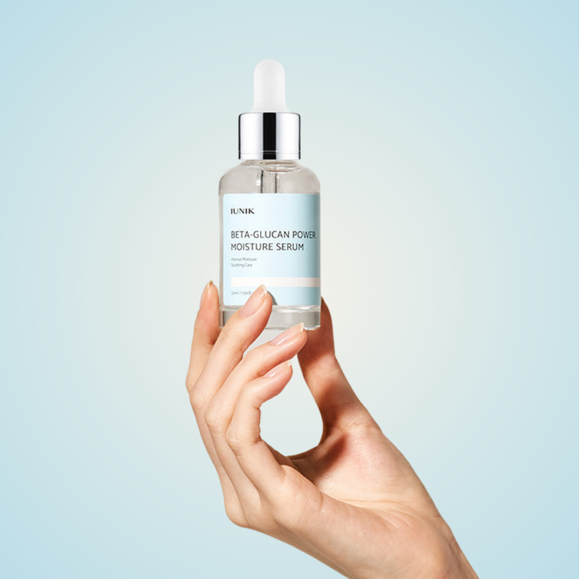 Hand holding iUNIK Beta-Glucan Power Moisture Serum 50ml with dropper cap