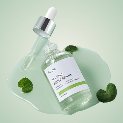 iUNIK Tea Tree Relief Serum bottle with centella leaves and texture