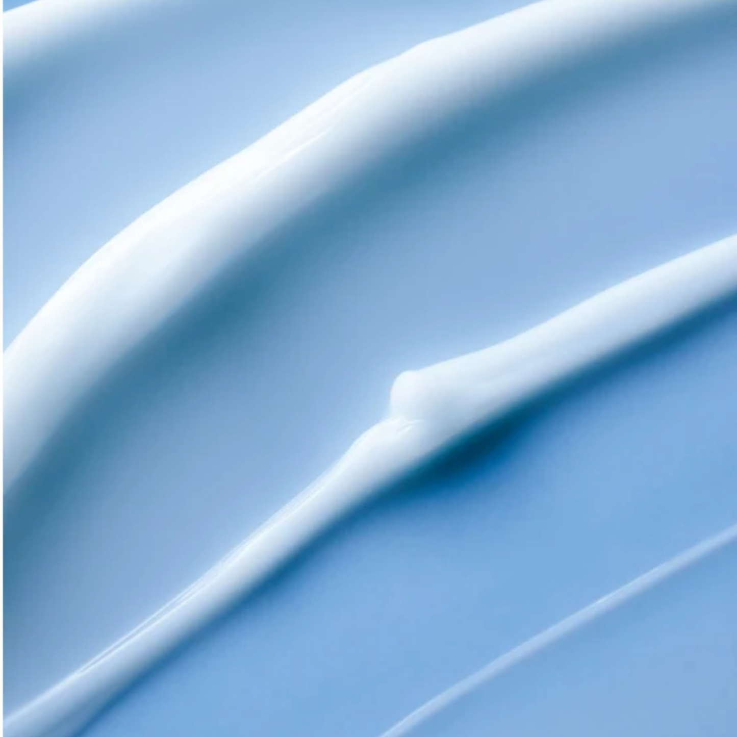 Close-up of LANEIGE Water Sleeping Mask EX hydrating cream texture streaked on blue surface