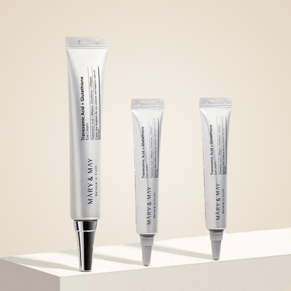 Mary & May Tranexamic Acid + Glutathione Eye Cream tubes displayed together on minimalist platform
