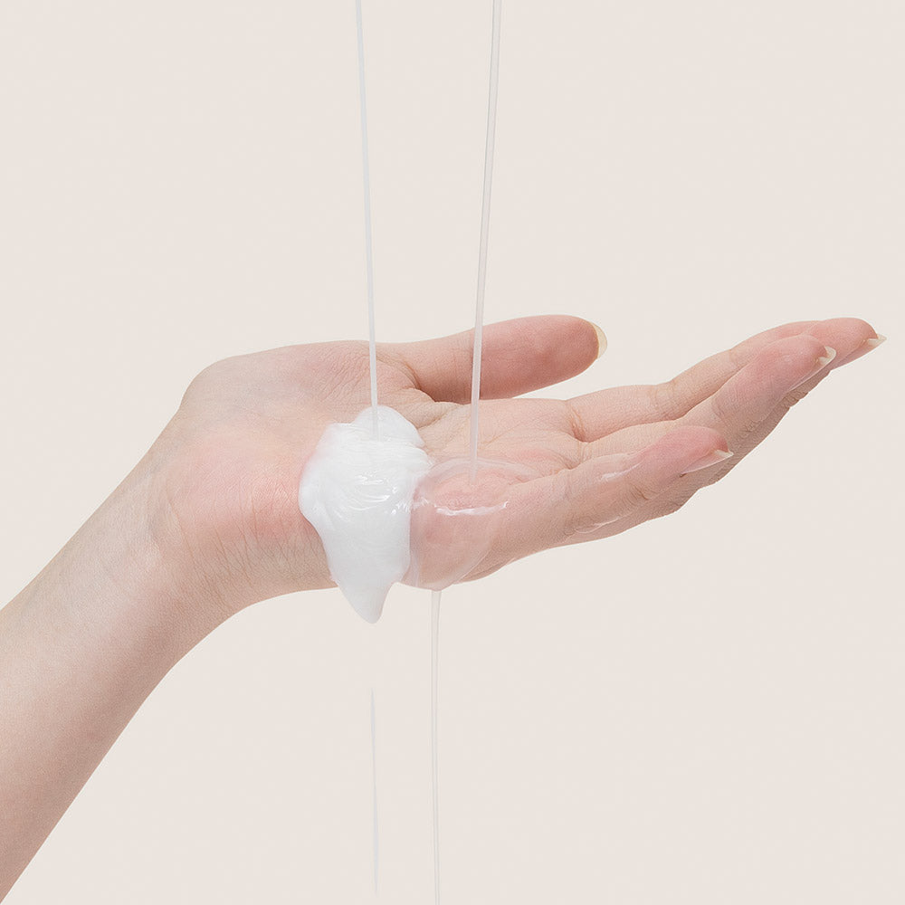 MARY & MAY Vitamin C+Bifida Lotion 120ml — lotion texture poured into a hand.