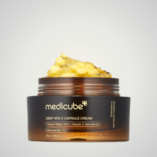 Open jar of medicube Deep Vita C Capsule Cream 55g showing vitamin C capsule texture.