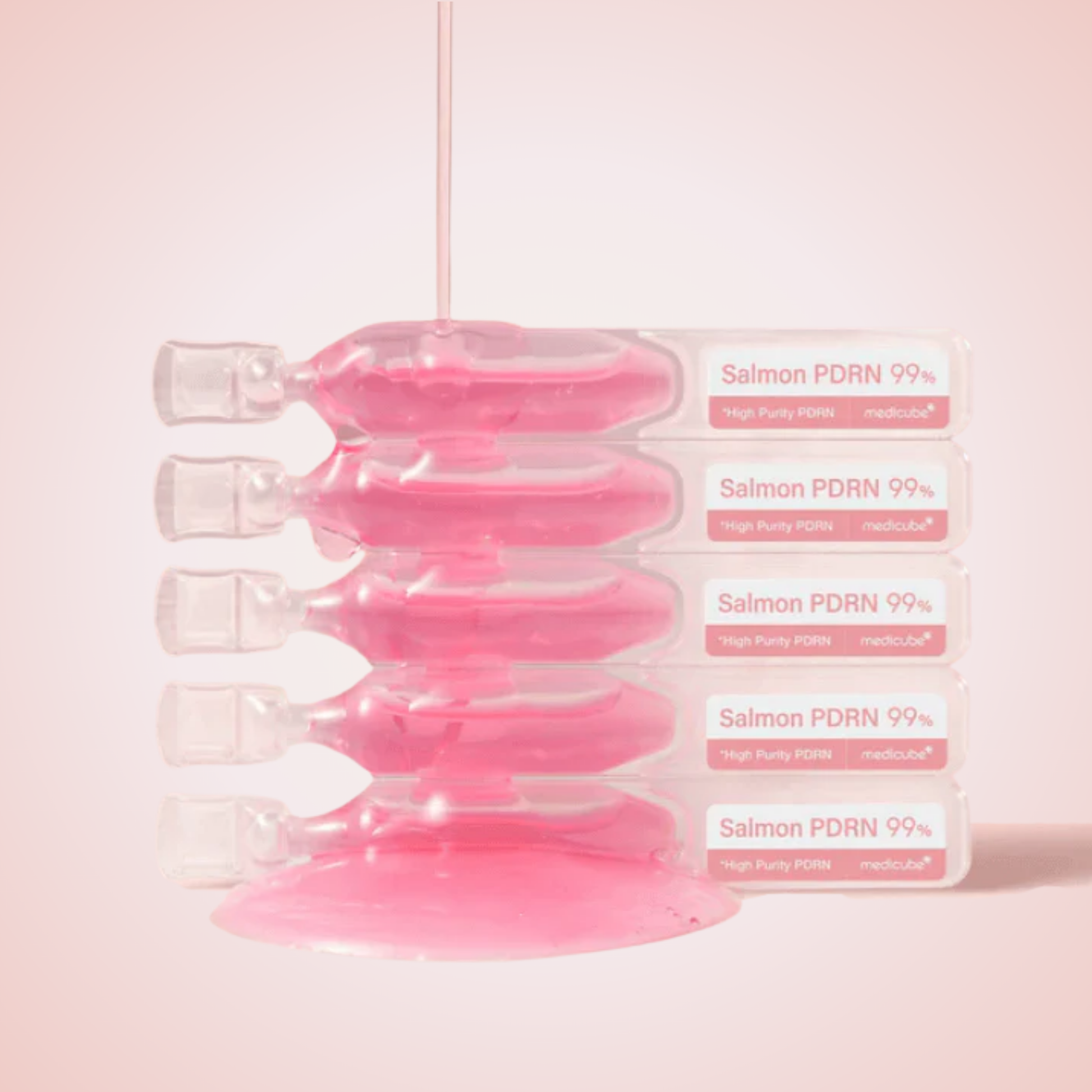 Close-up of Medicube PDRN Pink One Day Serum vials – rich pink ampoule for revitalized, smooth skin