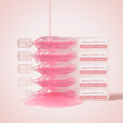 Close-up of Medicube PDRN Pink One Day Serum vials – rich pink ampoule for revitalized, smooth skin