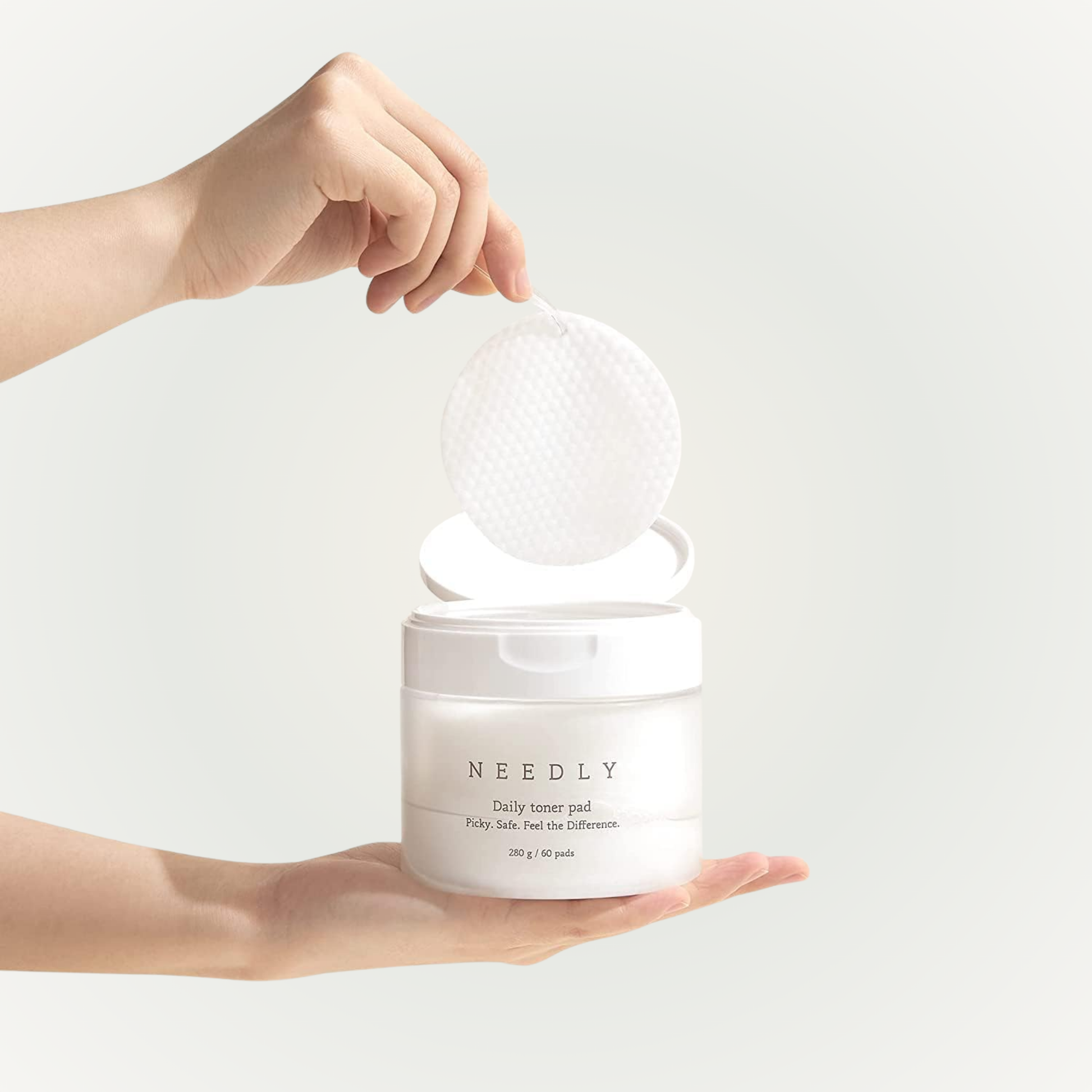 Applying Needly Daily Toner Pad on skin – mild exfoliation and hydration in one swipe