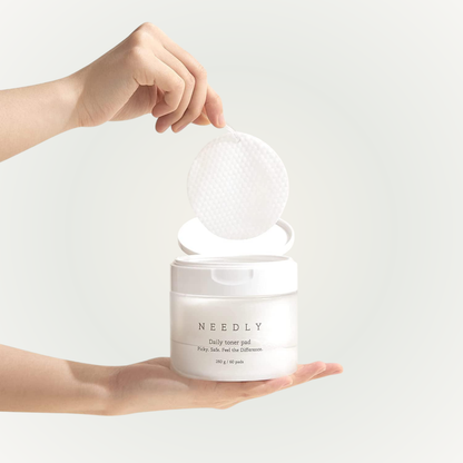 Applying Needly Daily Toner Pad on skin – mild exfoliation and hydration in one swipe