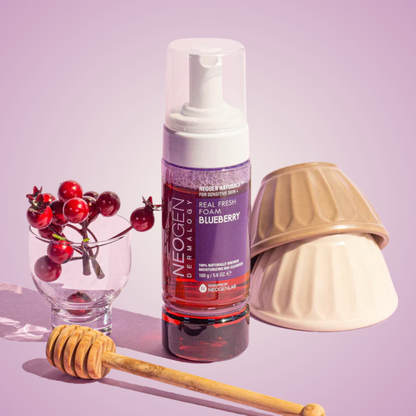 NEOGEN Dermalogy Real Fresh Foam Blueberry displayed with berries and honey props for antioxidant cleansing visual
