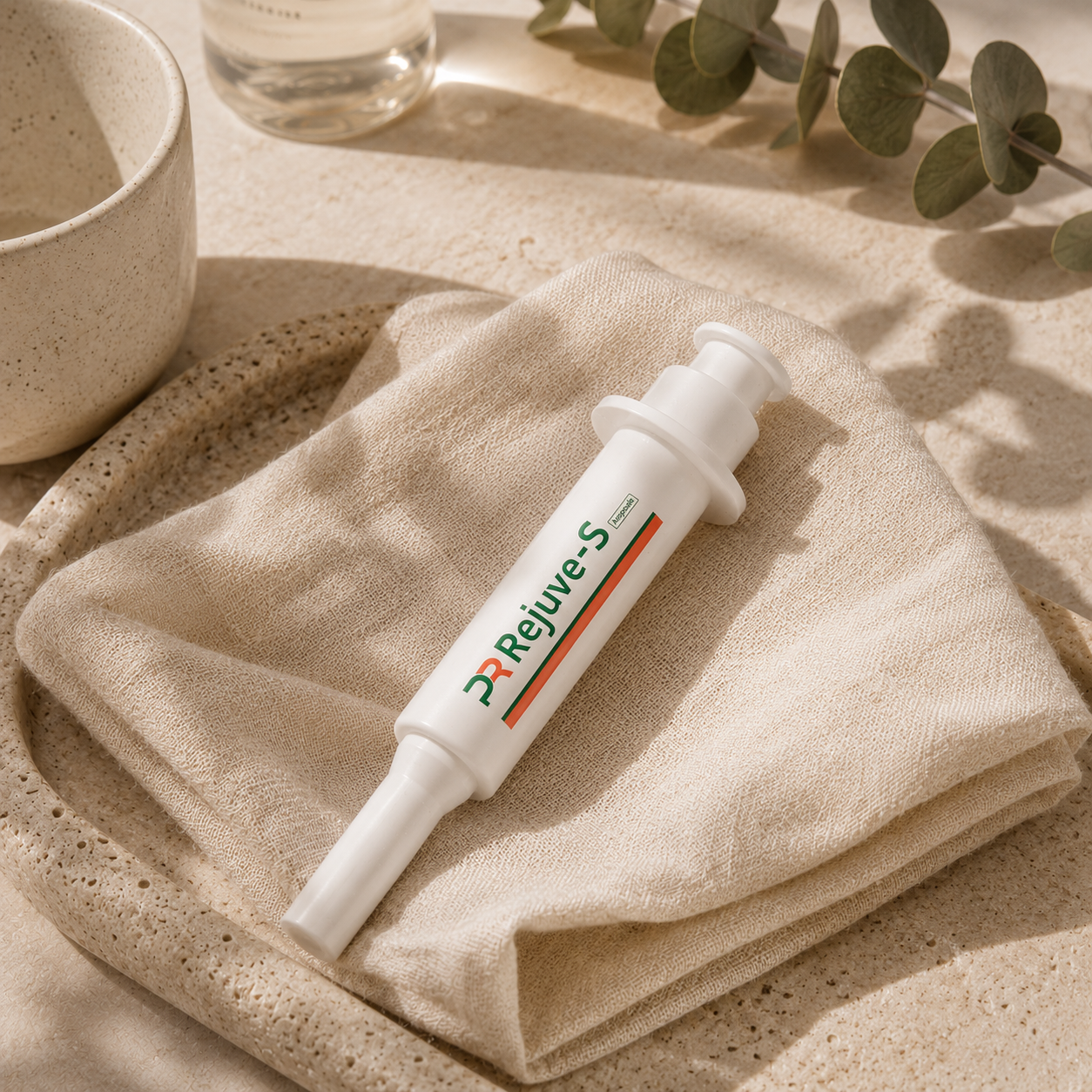 PharmaResearch Rejuve-S Ampoule resting naturally on a folded beige linen cloth atop a warm travertine stone tray, styled with a ceramic cup and eucalyptus branch in soft morning light, creating a calm, luxury Korean skincare ritual aesthetic.