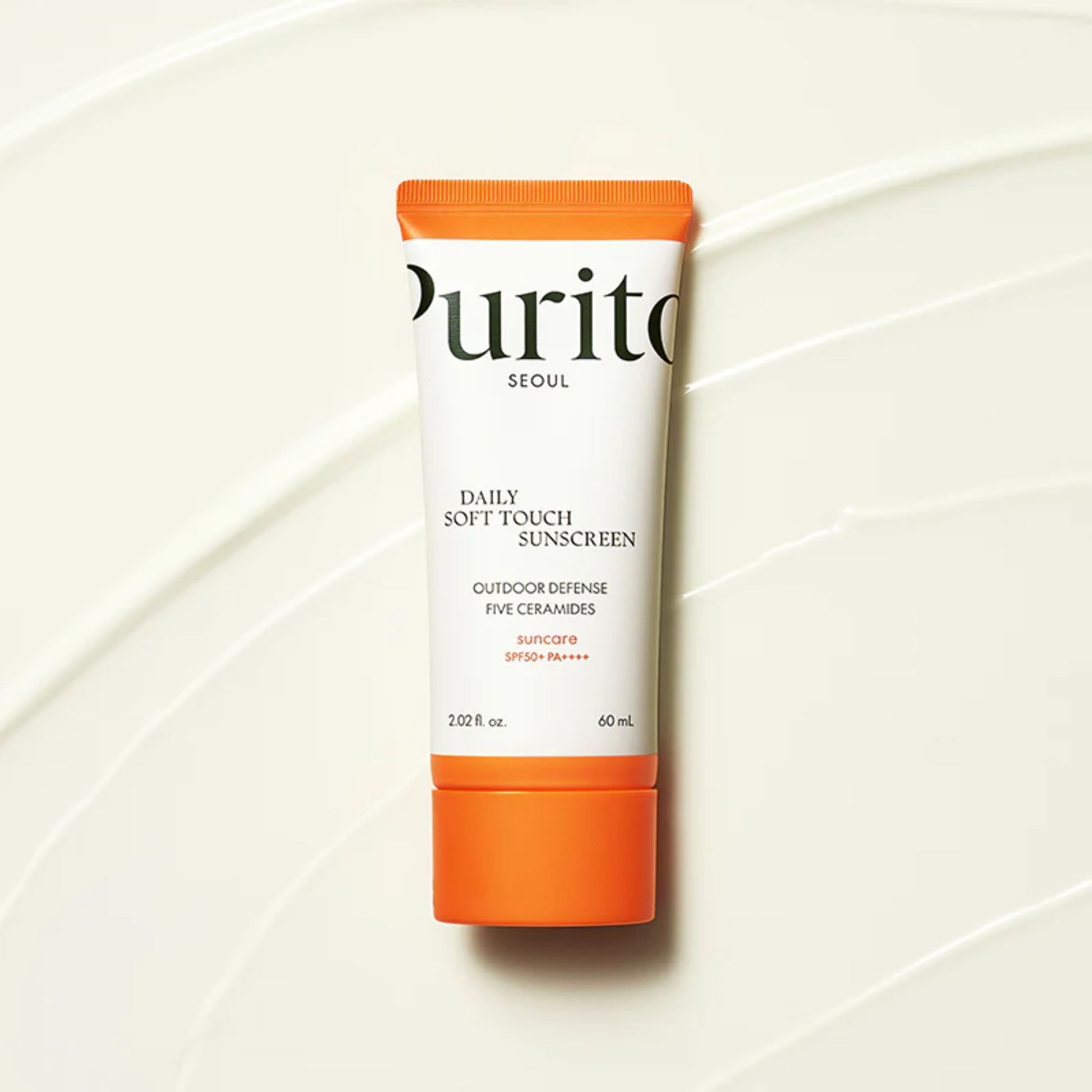 Purito SEOUL Daily Soft Touch Sunscreen SPF50+ PA++++ flatlay on smooth cream texture background