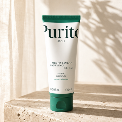 Purito Seoul Mighty Bamboo Panthenol Cream 100ml on warm travertine in soft morning light, luxury Korean skincare editorial hero photography highlighting moisture barrier care.