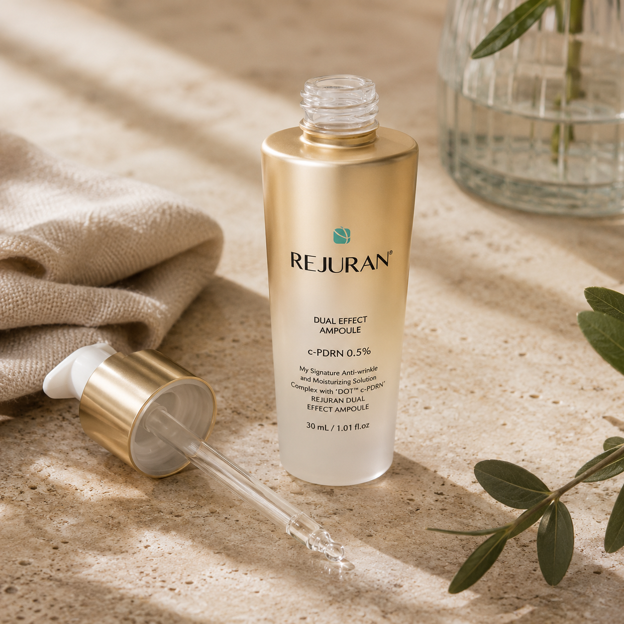 REJURAN Healer Turnover Ampoule Dual Effect PDRN 30ml beside a glossy hydrating serum texture, highlighting its lightweight ampoule consistency in a luxury beauty editorial setting.
