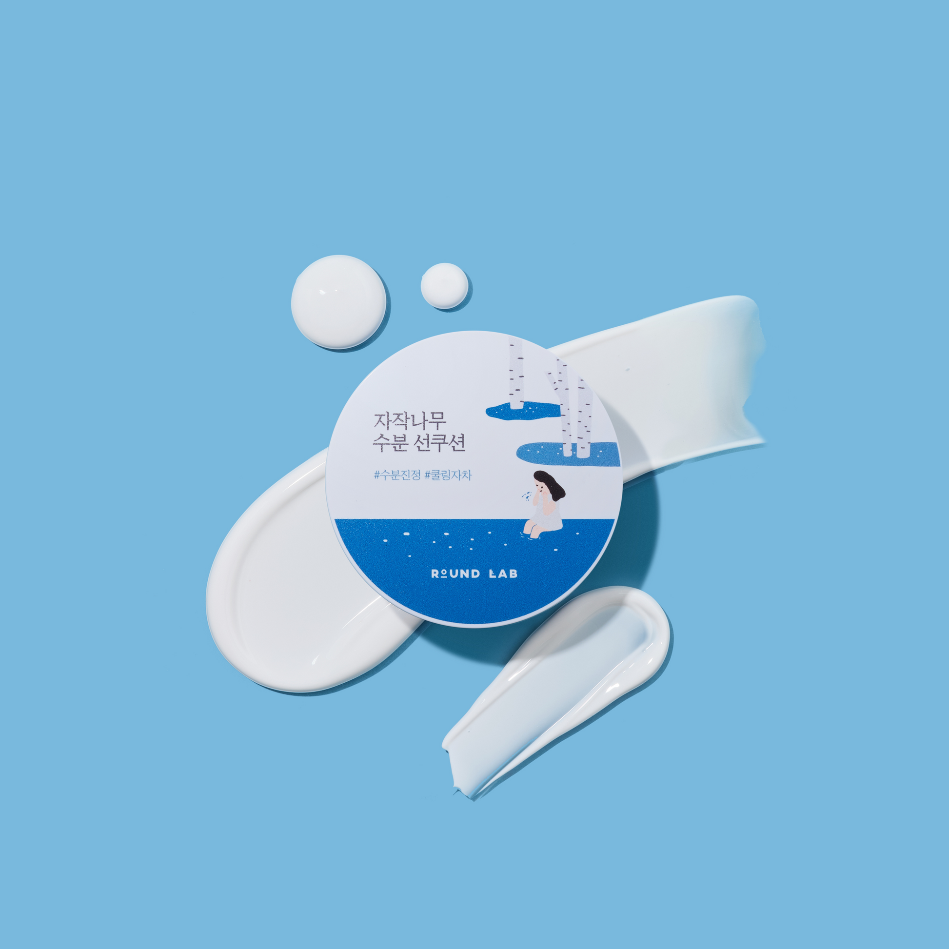 Round Lab Birch Juice Moisturizing UVlock Sun Cushion SPF50+ displayed on warm travertine with soft morning sunlight in a premium Korean skincare hero photo.