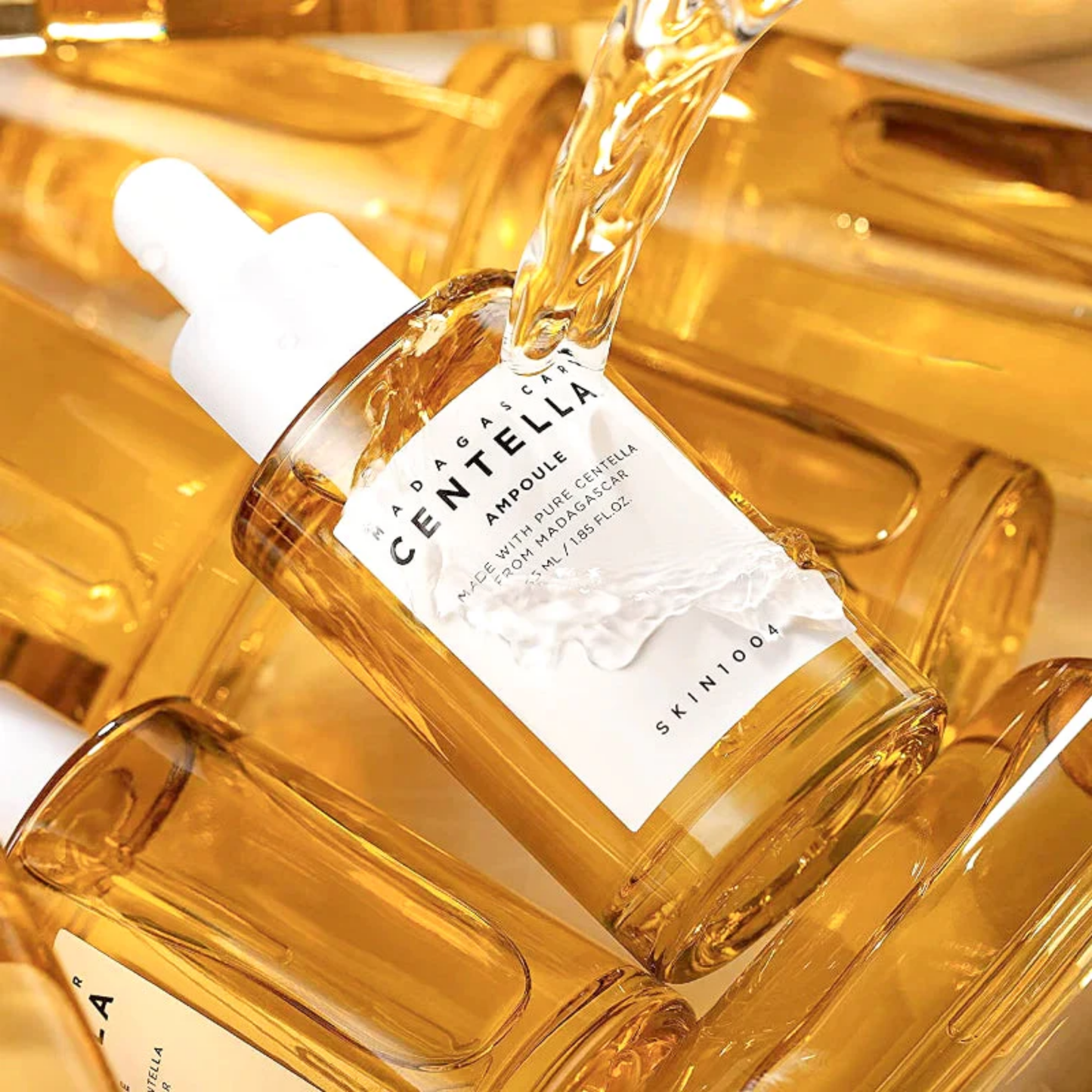 SKIN1004 Madagascar Centella Ampoule being poured – concentrated centella extract for hydration and skin barrier support.