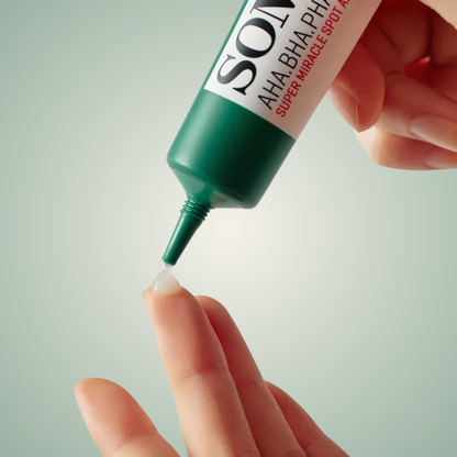 Applying SOME BY MI Super Miracle Spot Cream on fingertip