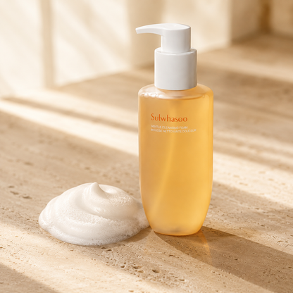 Sulwhasoo Gentle Cleansing Foam 200ml beside a soft white foam texture on warm travertine, highlighting its creamy cleansing formula in a luxury skincare editorial photo.