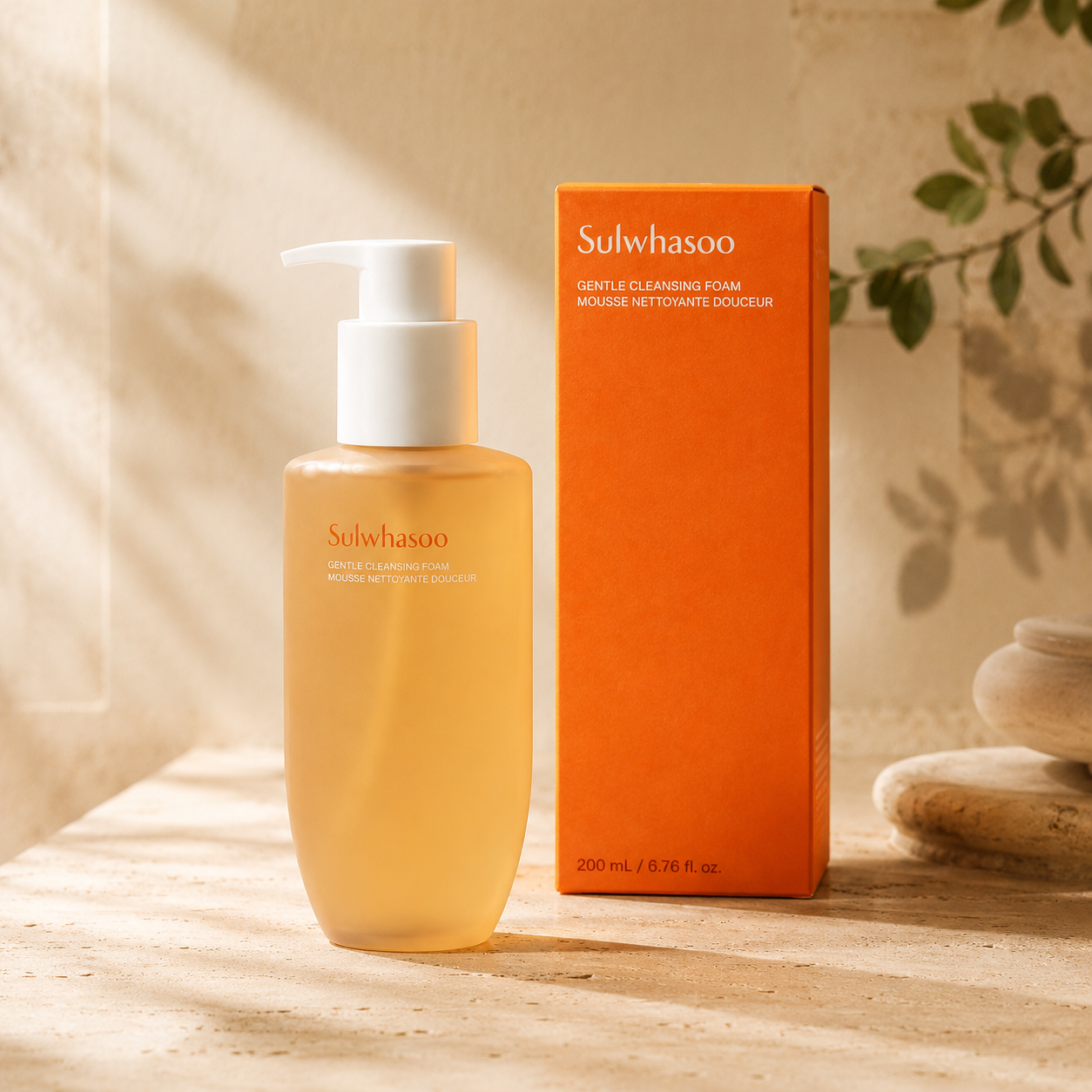 Sulwhasoo Gentle Cleansing Foam 200ml shown beside its orange product box on warm travertine with soft natural light and subtle botanical shadows.