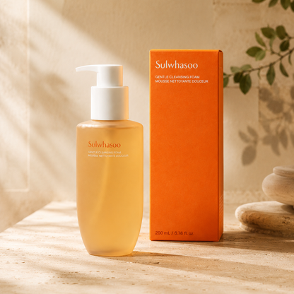 Sulwhasoo Gentle Cleansing Foam 200ml shown beside its orange product box on warm travertine with soft natural light and subtle botanical shadows.