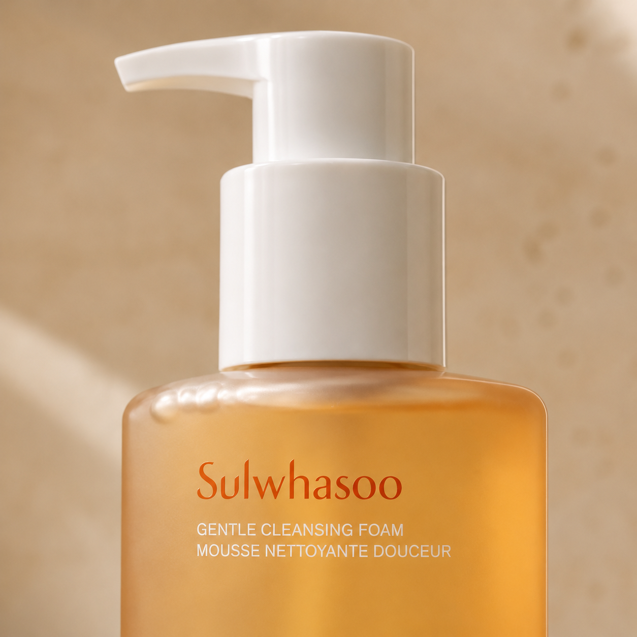 Close-up detail of Sulwhasoo Gentle Cleansing Foam 200ml showing the white pump, amber bottle, and refined packaging typography in soft morning light.