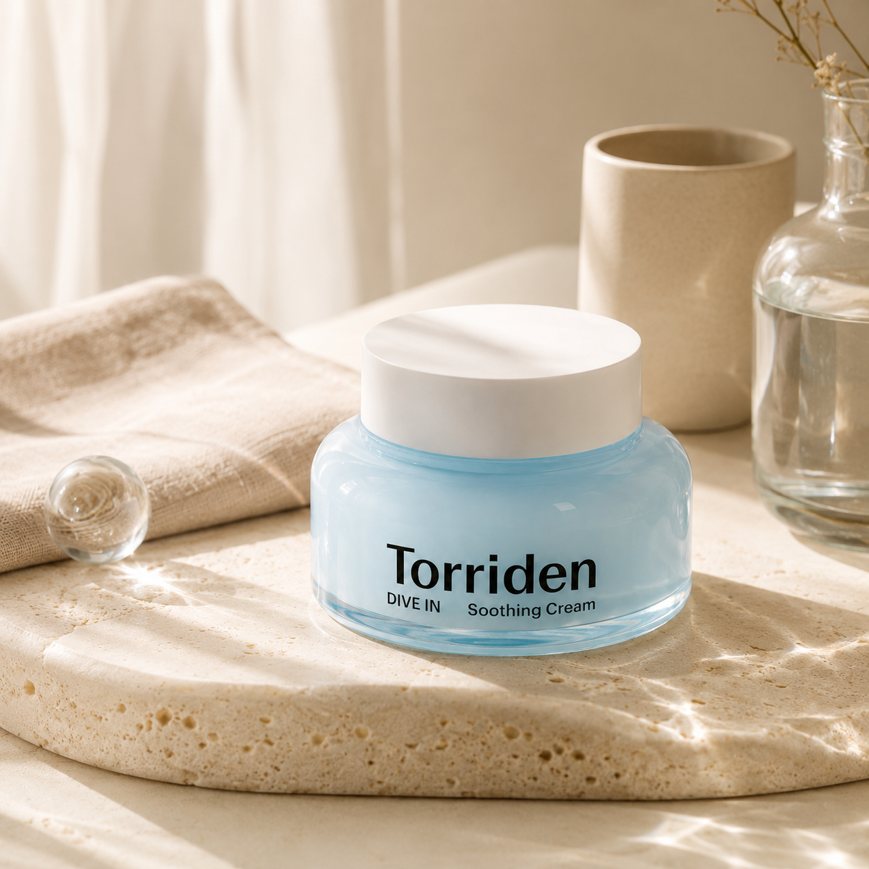 Torriden Dive-In Hyaluronic Acid Soothing Cream 100ml shown open with its cooling gel cream texture in soft morning light on warm travertine.